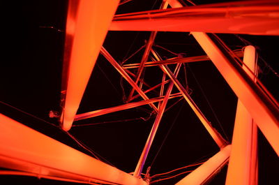 Low angle view of illuminated bridge at night