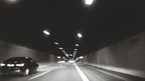 Road in illuminated tunnel