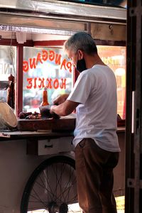 Full length of a man standing at his cart