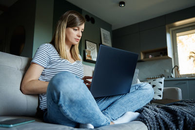 Woman at home using laptop. remote work at home office