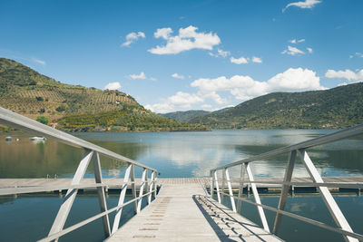 Jetty by lake against mountains