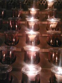 Close-up of illuminated candles on table