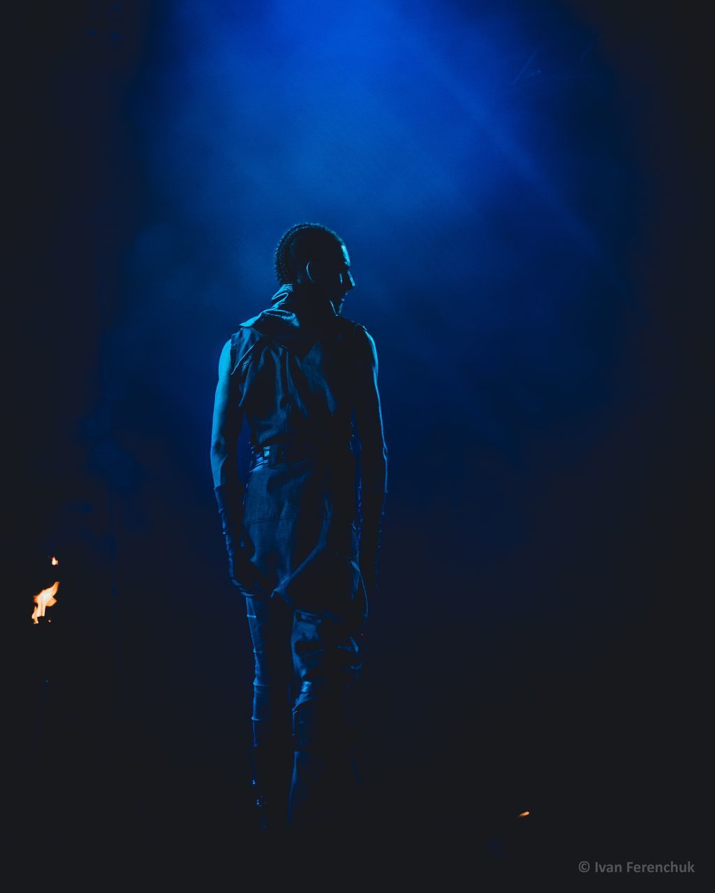 night, one person, illuminated, standing, full length, young adult, real people, three quarter length, performance, blue, front view, lifestyles, arts culture and entertainment, stage - performance space, young men, light - natural phenomenon, indoors, clothing, stage, nightlife