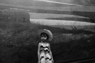 Cute girl standing against painting at homestead national monument of america