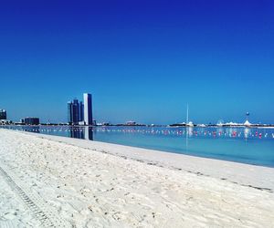 View of beach against clear blue sky