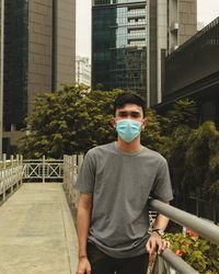 Man standing against building in city