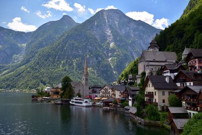 Houses by lake against mountains