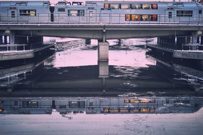 Bridge over river in city during winter