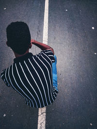 Rear view of woman standing on street in city