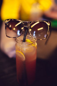 Close-up of sunglasses on cocktail