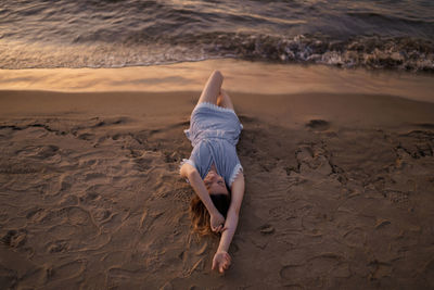 High angle view of woman relaxing on beach