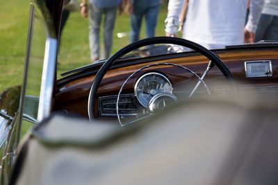 Close-up of people standing by car