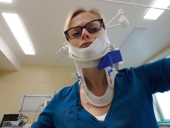 Portrait of young woman wearing neck brace