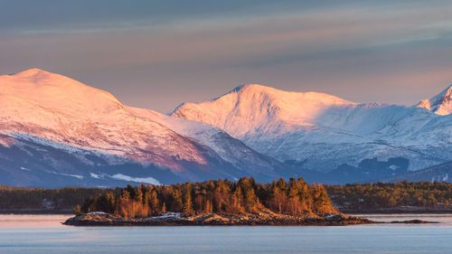 Scenic view of snowcapped mountains against sky during sunset