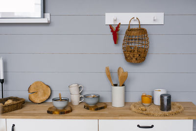 Modern kitchen interior with gray wooden panels on the wall in scandinavian style, crockery 