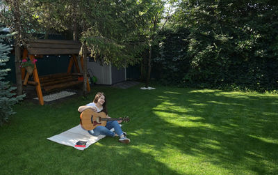 Woman sitting in yard