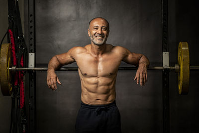 Portrait of shirtless man standing in gym