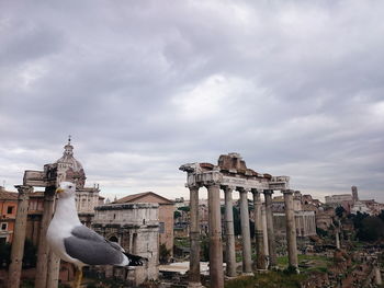 Statue of temple against cloudy sky