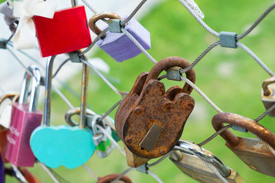 Close-up of padlocks on metal fence