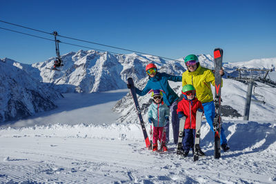 People skiing on snow covered landscape