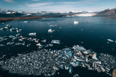 Aerial view of frozen sea against sky