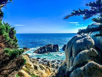 Scenic view of sea against clear blue sky