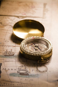 Close-up of navigational compass on map