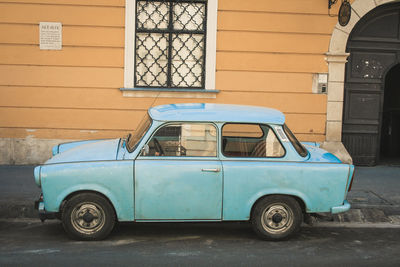 Vintage car on street against building