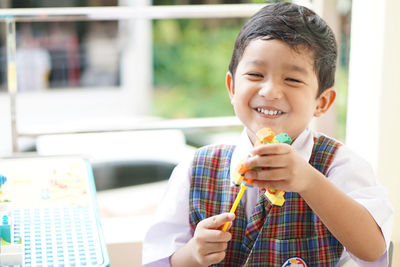 Portrait of smiling boy holding ice cream