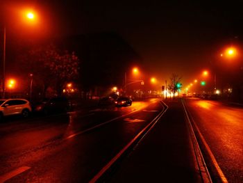 Cars on road in city at night