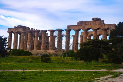 Ruins of historical building against cloudy sky