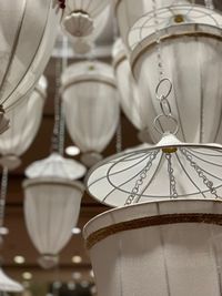 Low angle view of pendant lights hanging for sale in store