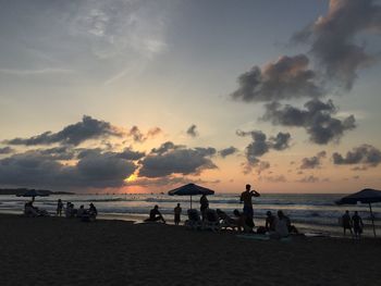 People on beach at sunset