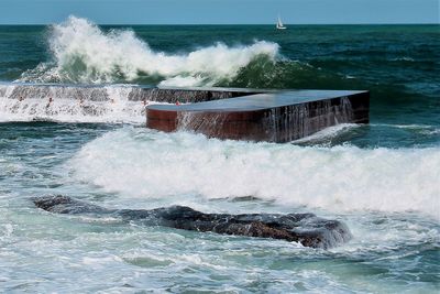 Waves breaking against sea