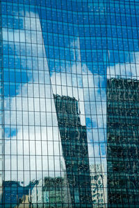 Low angle view of office building against blue sky