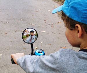 Close-up of boy riding bike