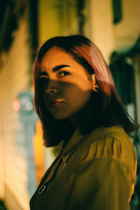 Portrait of young woman standing outdoors