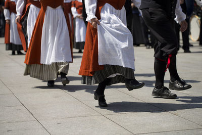 Low section of people walking on street