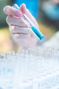 Cropped hand holding text tube in laboratory