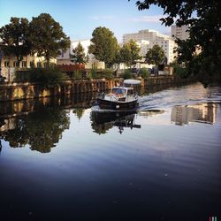 Boat at canal by buildings