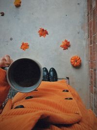 Low section of person holding orange cake