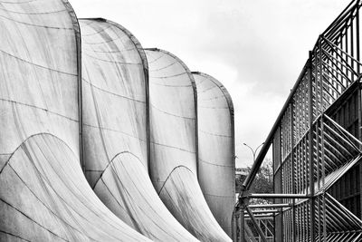 Low angle view of industry against sky