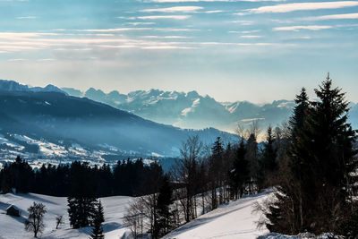 Scenic view of snow covered mountains against sky