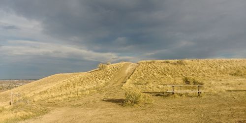 Scenic view of sand dune against sky