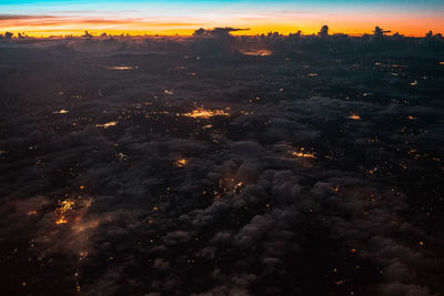 Aerial view of illuminated city at night