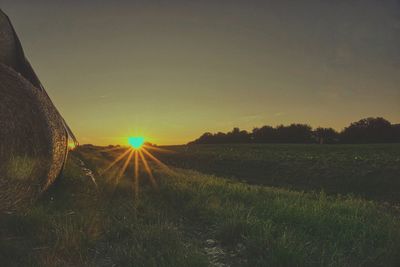 Scenic view of field against sky during sunset