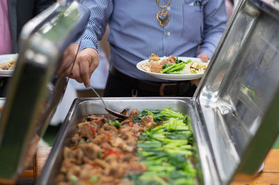 Midsection of man preparing food