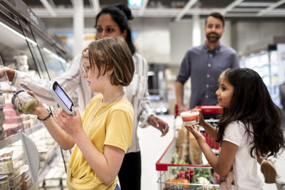 Family doing shopping in supermarket