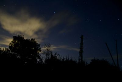 Low angle view of silhouette trees against sky at night