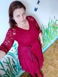 Portrait of young woman sitting on floor at home